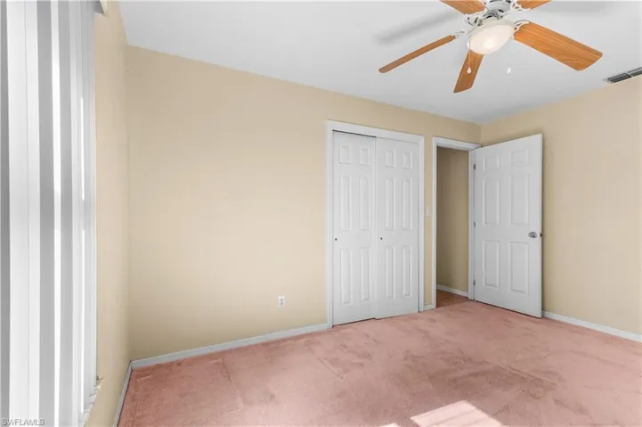 Guest bedroom #2 with carpet, a ceiling fan, and a closet