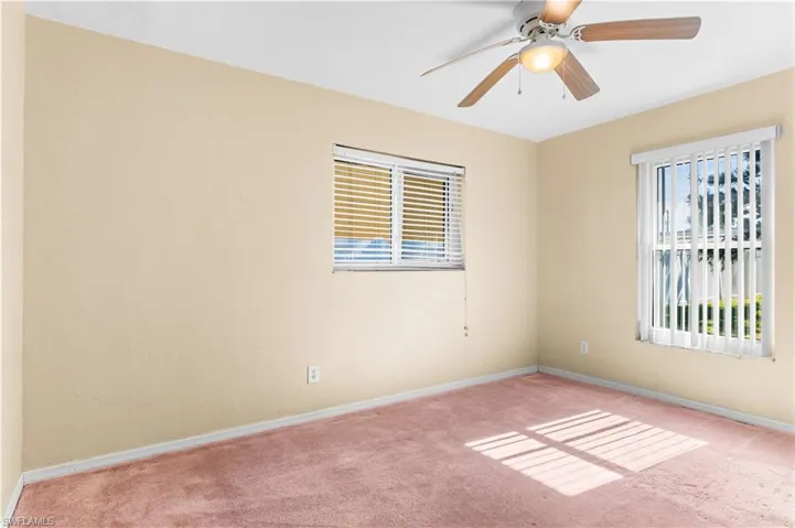Guest bedroom #2 with carpet and ceiling fan