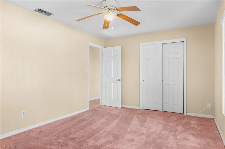 Guest bedroom #1 featuring a ceiling fan, carpet flooring, and a closet