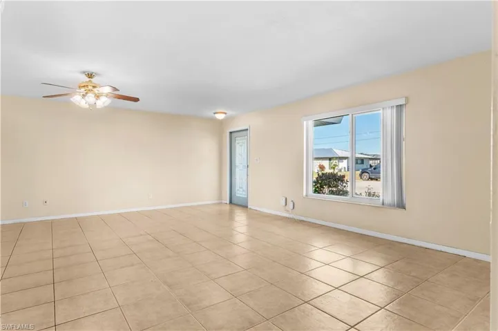 Spare room with a ceiling fan and light tile patterned flooring