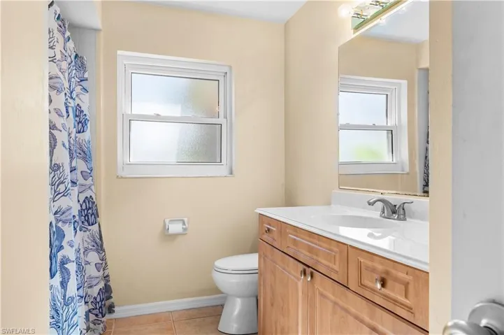 Bathroom featuring vanity, a shower with shower curtain, and light tile patterned floors