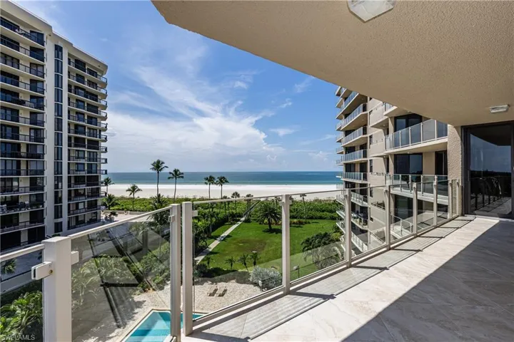 Balcony with view of water and beach