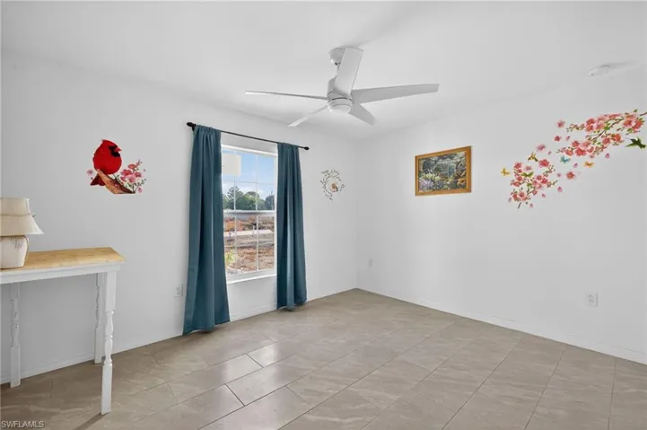 Bedroom featuring ceiling fan and baseboards