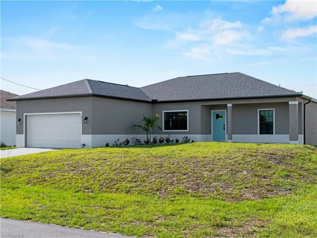 View of front facade featuring an attached garage, stucco siding, a front lawn, concrete driveway, and a shingled roof