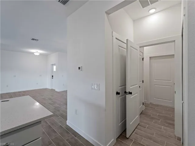 Corridor with wood finish floors and baseboards