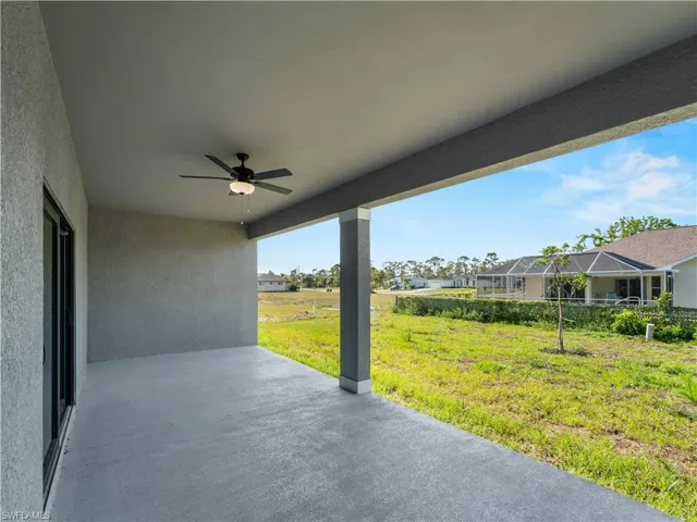 View of patio with a ceiling fan and a residential view