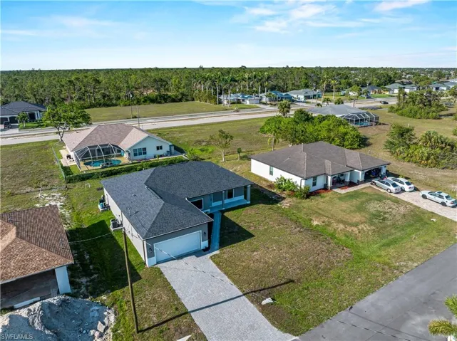 Aerial perspective of suburban area featuring a forest