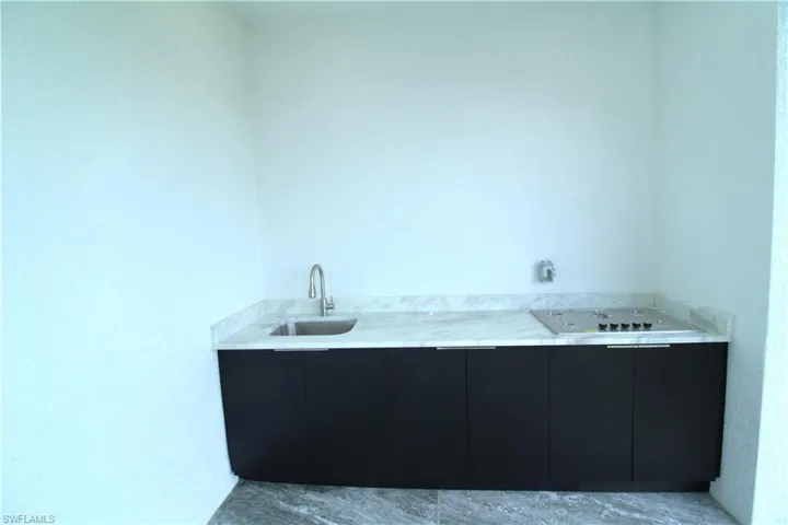 Bathroom featuring tile floors and sink