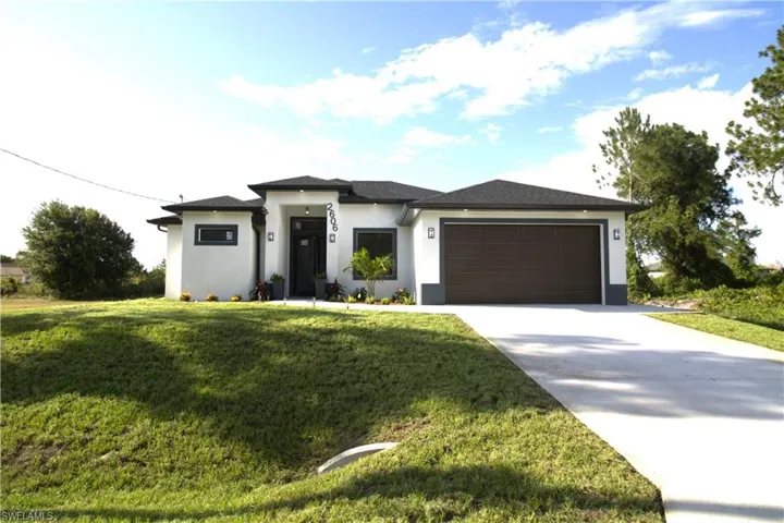 Prairie-style house featuring a garage and a front yard
