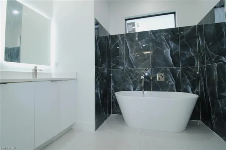 Bathroom featuring tile walls and tile floors