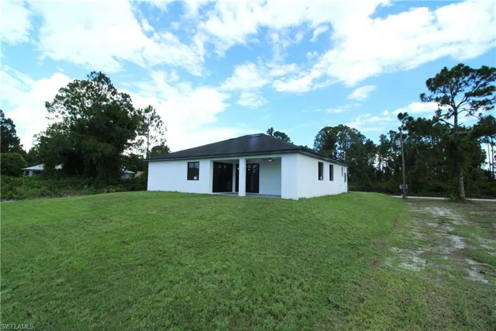 Rear view of house with a lawn