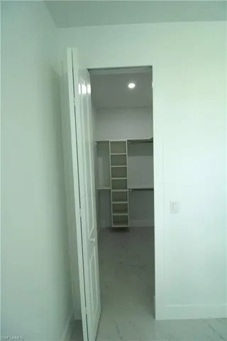 Walk in closet featuring tile floors