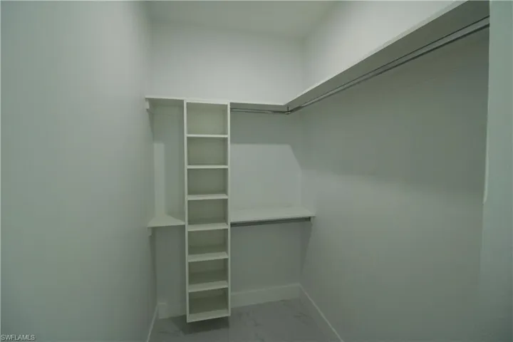 Spacious closet with tile flooring