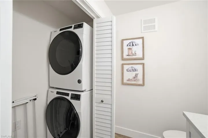 Laundry attached to Half Bathroom with ample storage.