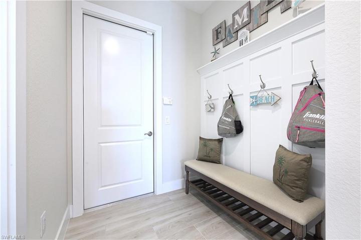 Upon entering the home through the garage, you will notice the mud room with architectural wall treatment.