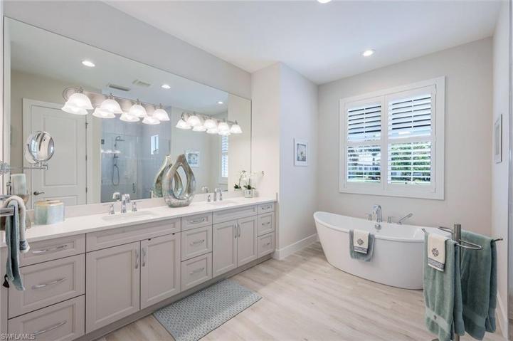 Primary bathroom with large walk in shower and free standing soaking tub.