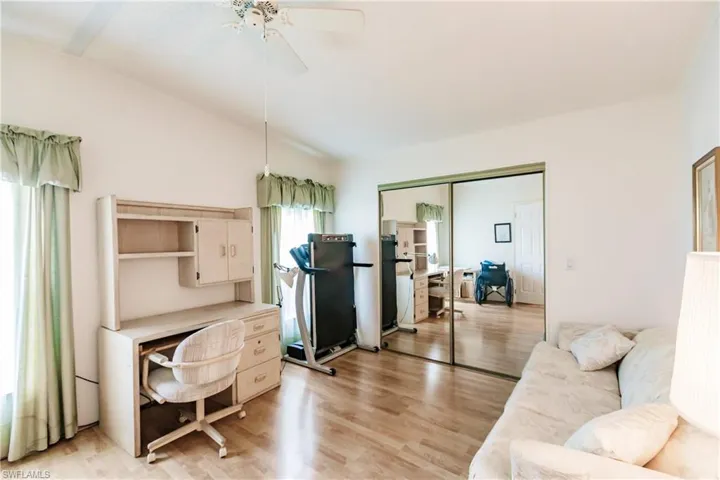 Living room with light hardwood / wood-style flooring and ceiling fan