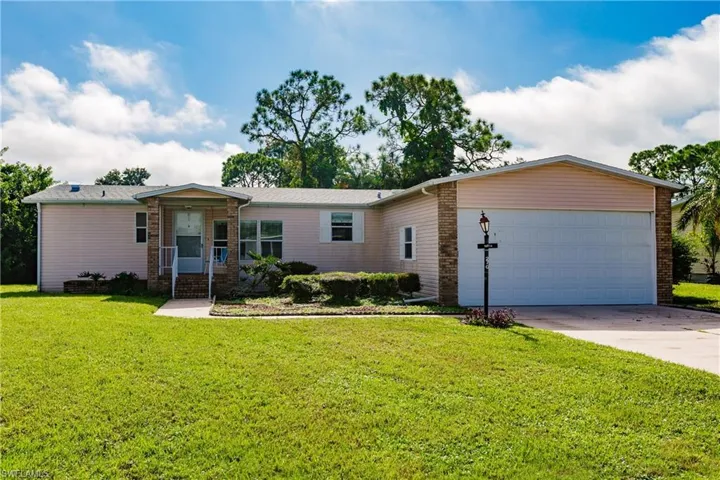Ranch-style house with a front lawn and a garage