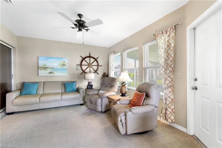Living room with carpet and ceiling fan