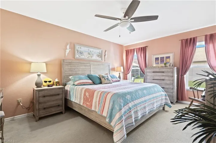 Bedroom featuring light colored carpet and ceiling fan