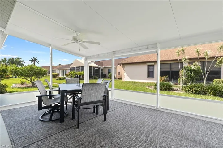 Sunroom / solarium featuring outdoor dining area and a ceiling fan