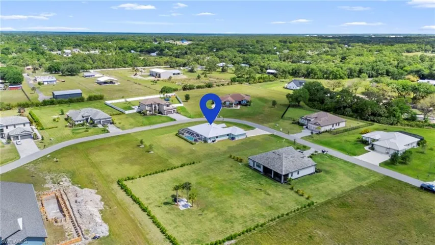 Aerial perspective of suburban area featuring a heavily wooded area