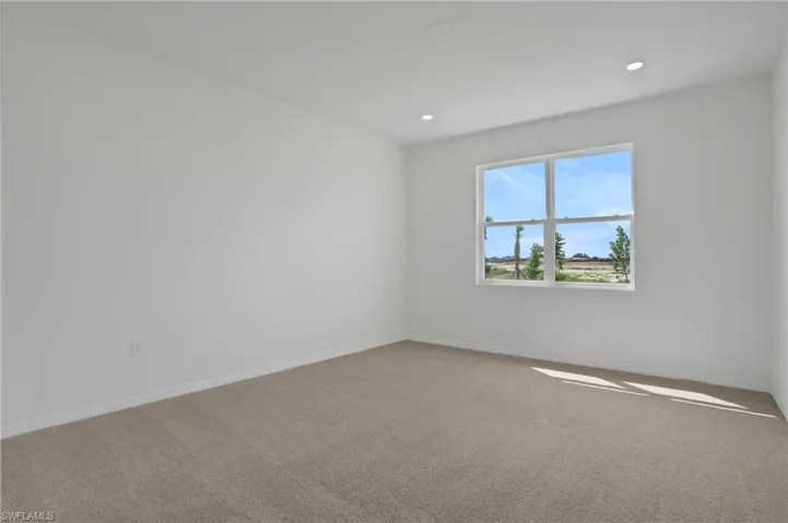 Unfurnished room with light carpet and recessed lighting