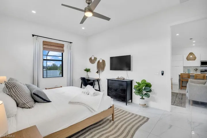 Bedroom with light marble finish floors, a ceiling fan, and recessed lighting