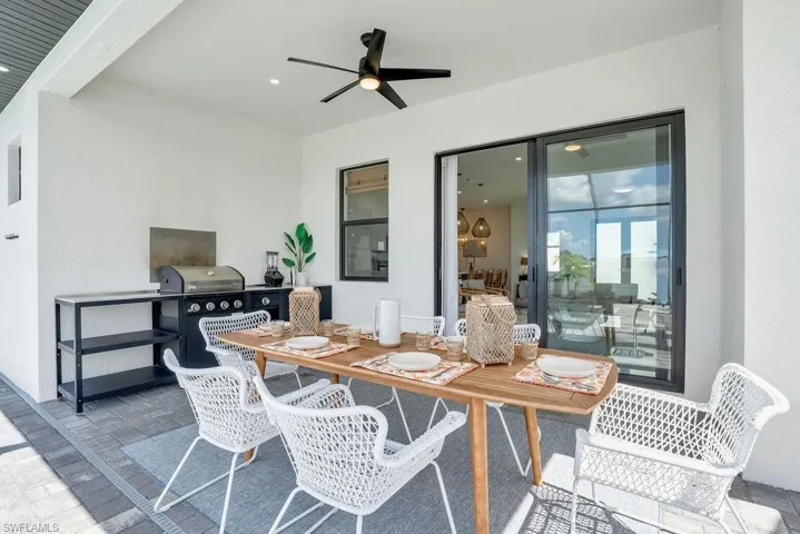 View of patio featuring outdoor dining area, a ceiling fan, and an outdoor kitchen