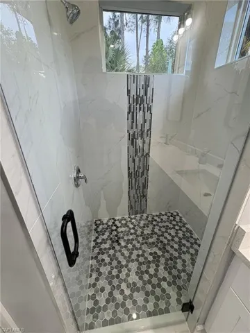 Bathroom with a marble finish shower