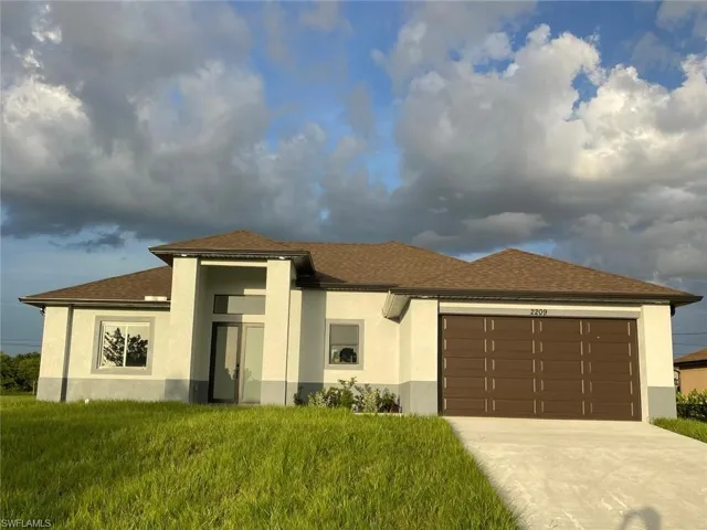 Prairie-style house with a garage and a front yard