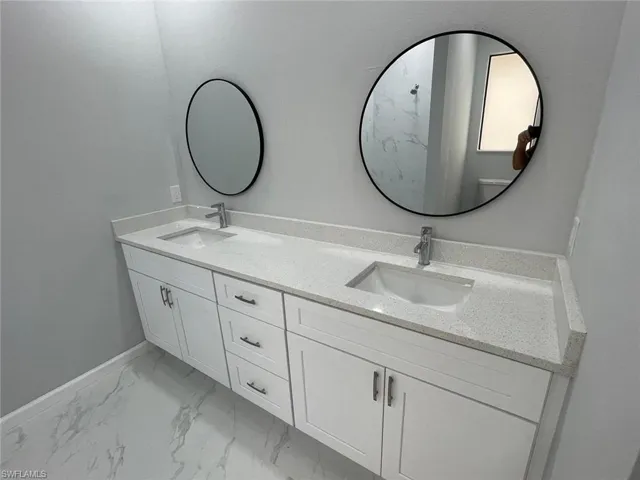 Bathroom featuring dual vanity and tile patterned floors