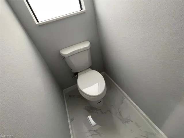 Bathroom with tile patterned floors and toilet
