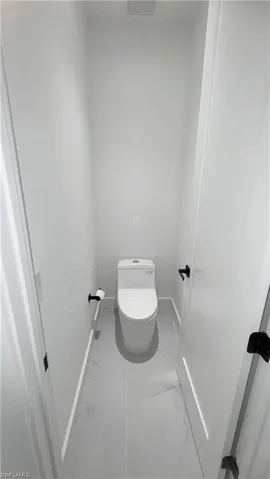 Bathroom with baseboards and light marble finish floors
