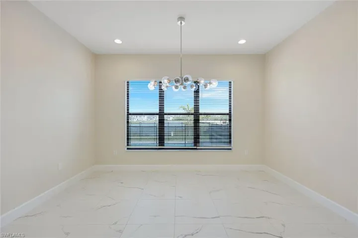 Unfurnished dining area featuring a notable chandelier