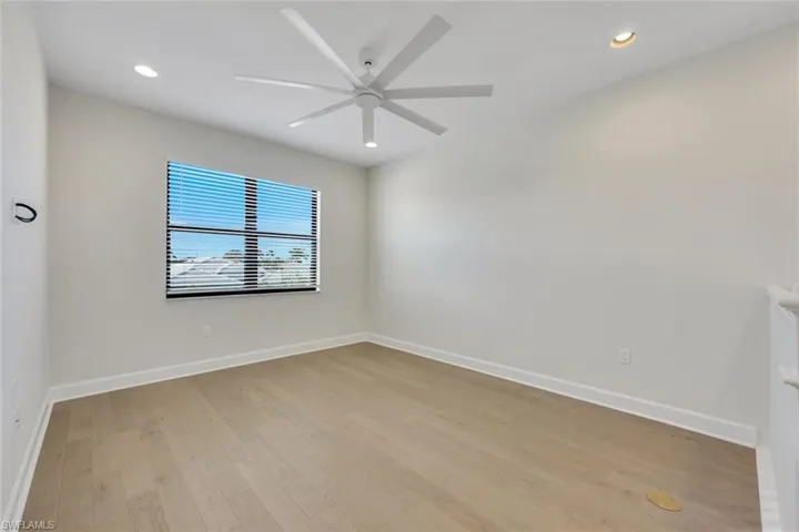 Empty room featuring ceiling fan and light hardwood / wood-style flooring