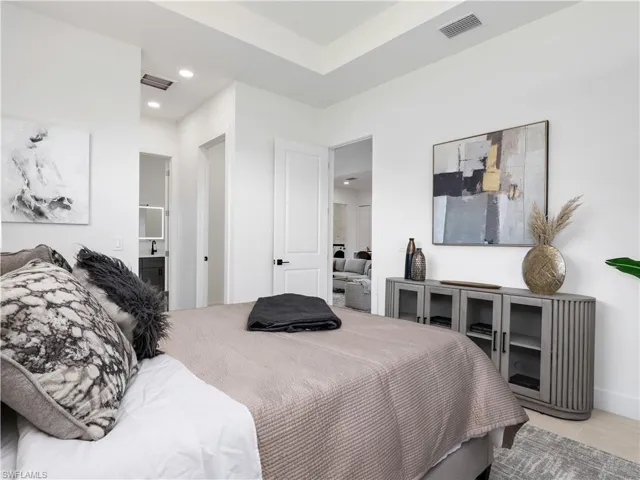 Bright interior space featuring light wood-finish flooring, white baseboards, and clean white walls