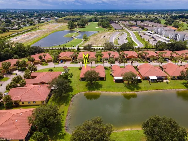 Aerial view of residential area featuring a large body of water