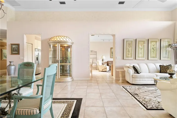 Living room featuring tile patterned flooring and ornamental molding