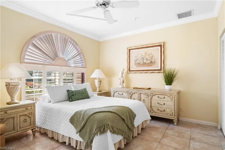 Guest Bedroom featuring ceiling fan, ornamental molding, and light tile patterned floors