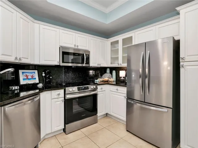 Kitchen with New Stainless-Steel Appliances, Backsplash, Granite Counters, & Tray Ceiling