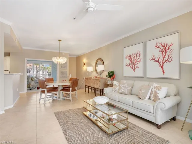 Living Room & Dining Area with Crown Molding & Ceiling Fan & Entrance to the Den