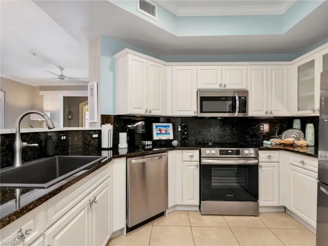 Kitchen with New Stainless-Steel Appliances & Single Basin Sink, Backsplash, Granite Counters, & Tray Ceiling