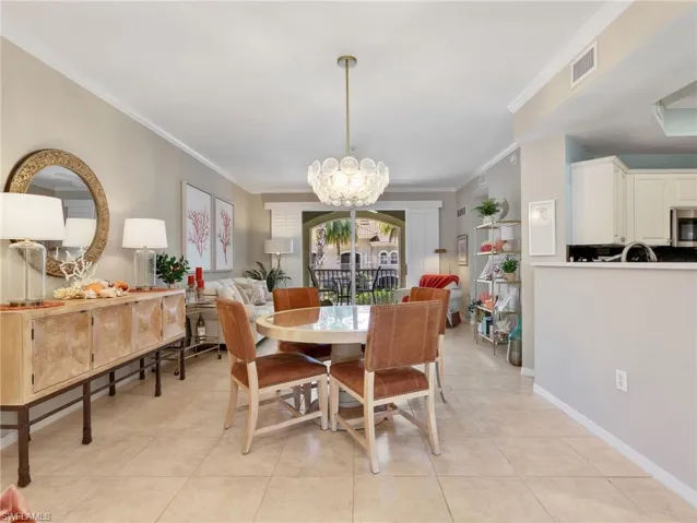 Dining Area & Living Room with Crown Molding & Sliders with Plantation Shutters