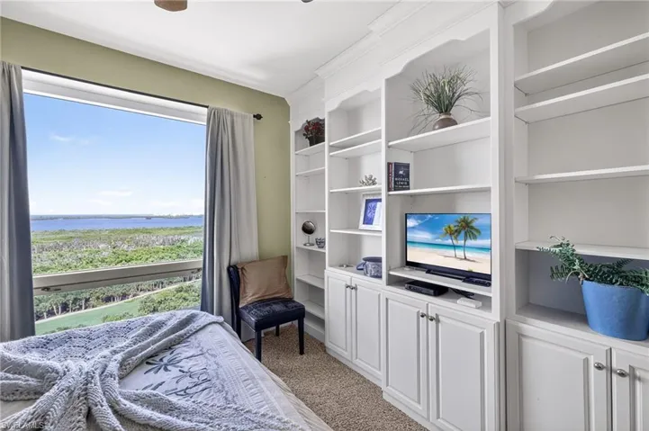 Bedroom with light colored carpet and ceiling fan