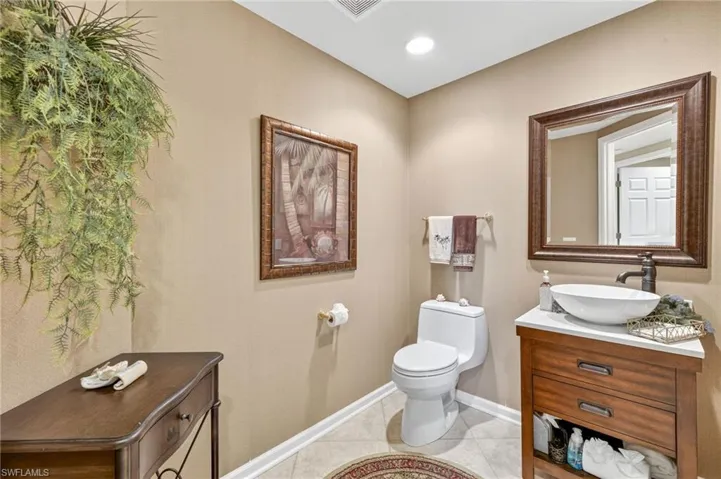 Bathroom with vanity, light tile patterned flooring, and recessed lighting