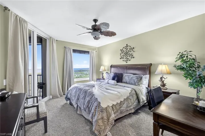 Bedroom featuring access to outside, carpet flooring, and ceiling fan