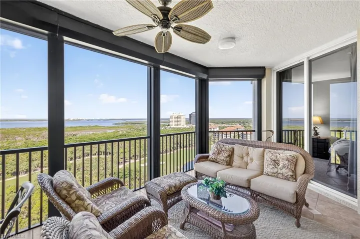 Featuring a water view, a balcony, an outdoor hangout area, a ceiling fan, and tile patterned floors
