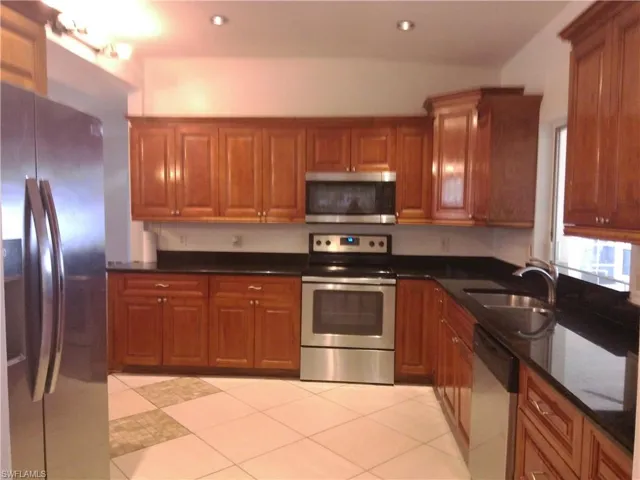 spacious kitchen w/ pass through window to patio