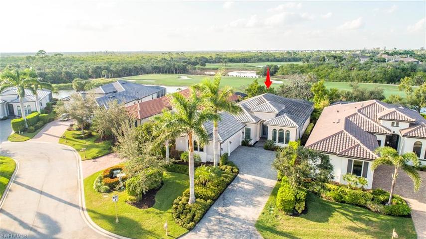 Plenty of parking on the long paver driveway leading to side load 3-car garage